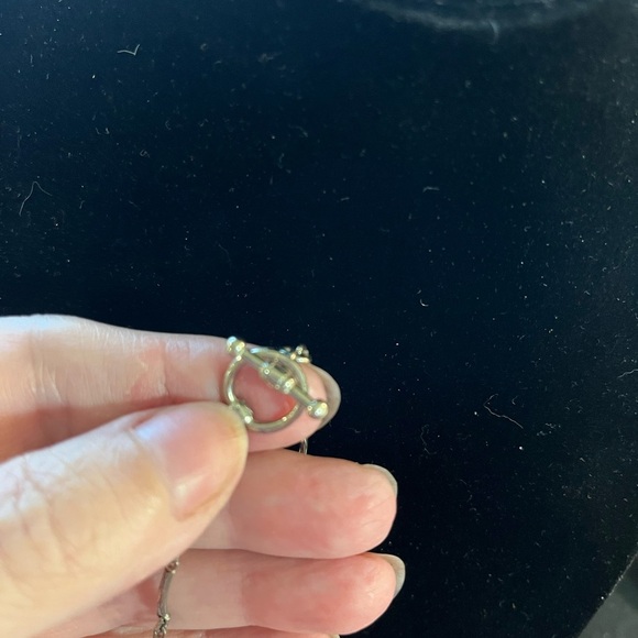 Brown teardrop beads surround the silver tone necklace. - Picture 2 of 2